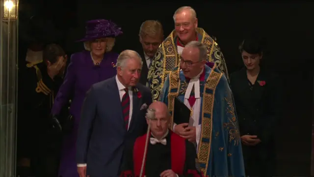 Prince Charles, followed by his wife Camilla, walk into the abbey