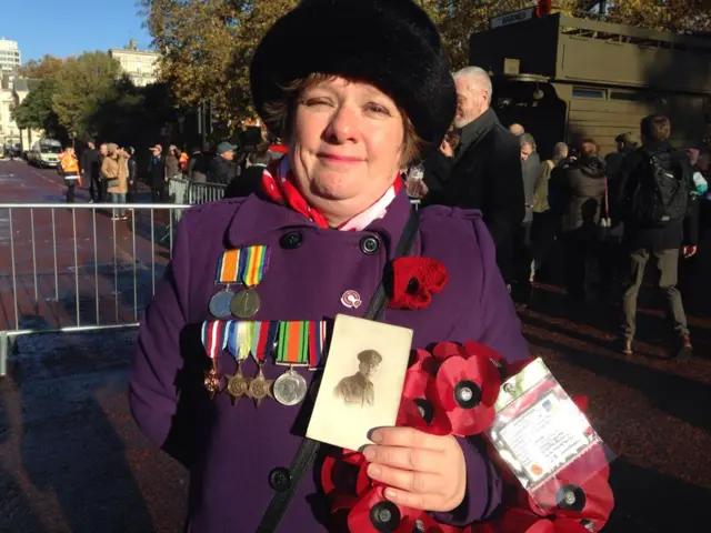 Emma Silk holds a photograph of her grandfather aged 17