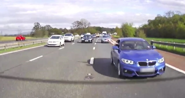 BMW driver waving at Highways officer