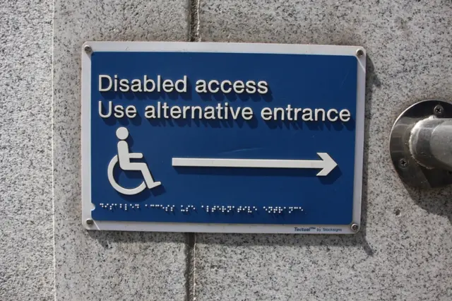 Sign saying disabled access use alternative entrance