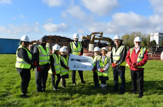 Four councillors, principal George Faux in the middle and children from Lyng primary school