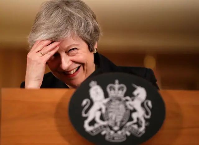 Mrs May shares a joke with journalists after delivering her serious message - she is sticking to her Brexit deal