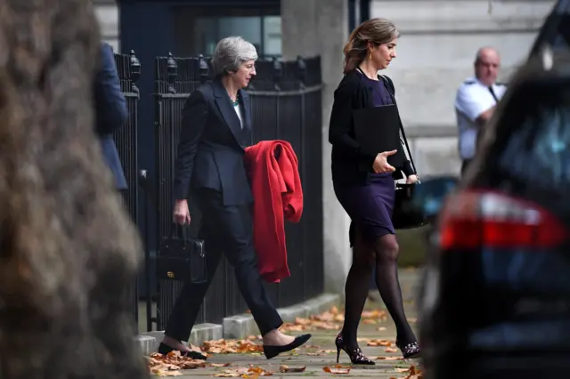 Theresa May leaves Downing Street through the back entrance after Esther McVey became the second minister to quit