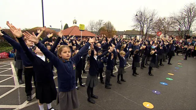 Children at Kimberley Primary School doing a "flash mob"