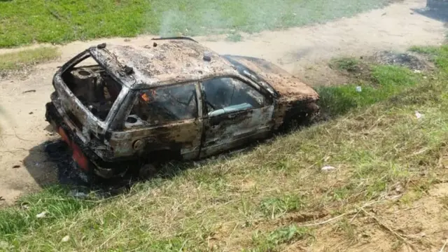 Burnt-out car at Kinshasa University, DR Congo