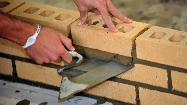 Builder building a wall