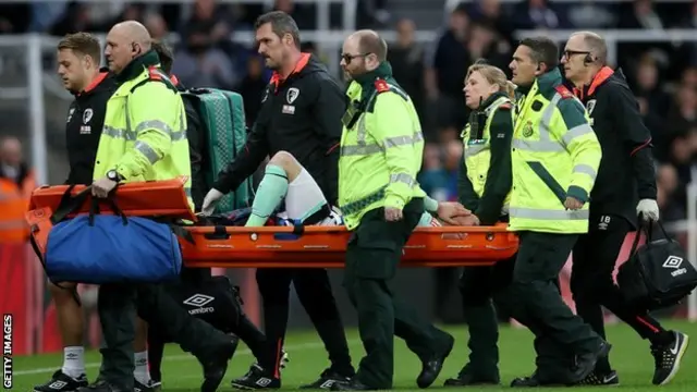 Adam Smith being stretchered off