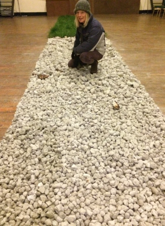 Woman standing on strip of stones