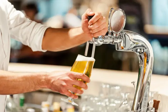 A beer being poured at a bar