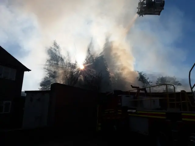 Sun shines through plume of smoke