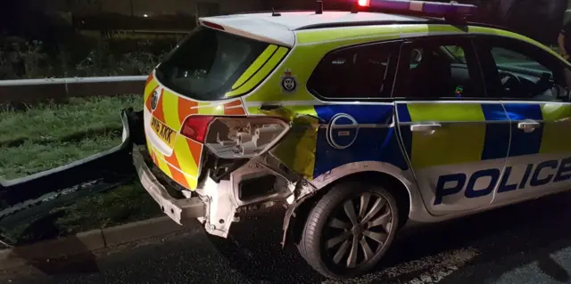 Police car hit by lorry