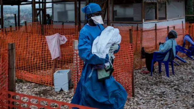 A health worker carries a four-day-old baby suspected of having Ebola, into a MSF supported Ebola Treatment Centre (ETC) on 4 November 2018 in Butembo, DR Congo