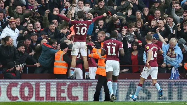 Aston Villa fans and players celebrate