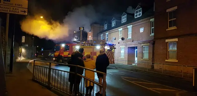 People watch the fire