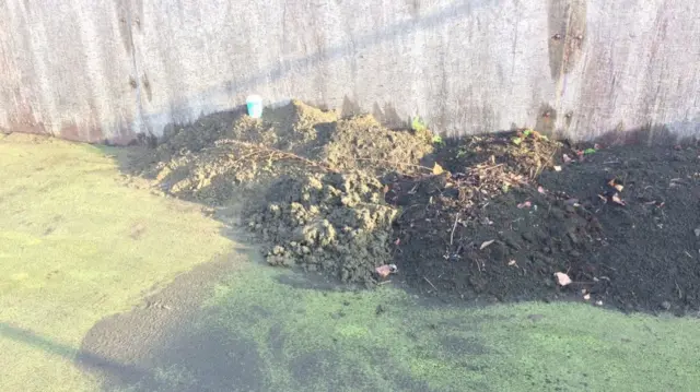 A pile of dirt on the artificial pitch