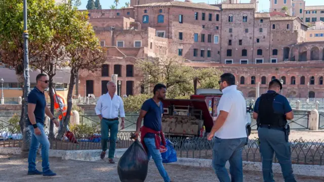 A refugee collects his belongings after being evicted from Piazza Venezia in September 2017 in Rome, Italy.