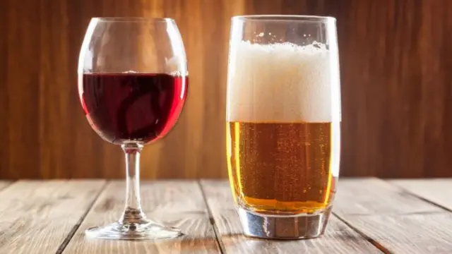 Red wine glass and glass of light beer