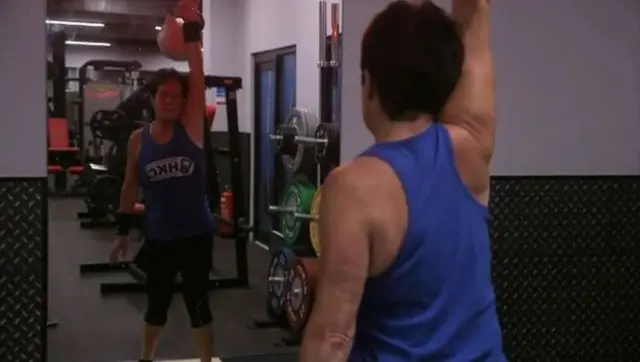 June Sawdon lifting a kettlebell and looking in the mirror