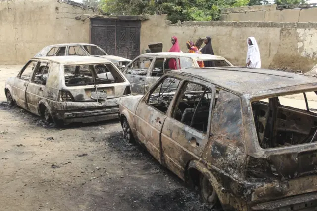 The wreckage of cars damaged by an attack on a market are seen on September 20, 2018, in Amarwa, some 20 kilometres (12 miles) from Borno state capital Maiduguri