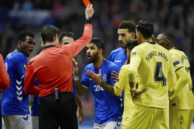 Daniel Candeias pleads his innocence as a red card is shown his way