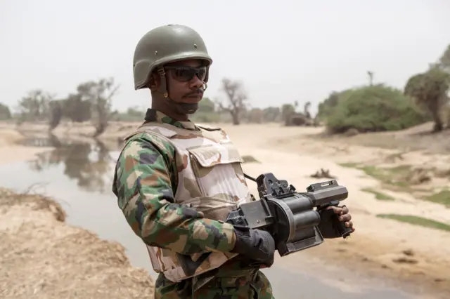 A Nigerian soldier, with a grenade launcher, stands guard near the Yobe river, that separates Nigeria from Niger, on the outskirt of the town of Damasak in North East Nigeria on April, 25 2017