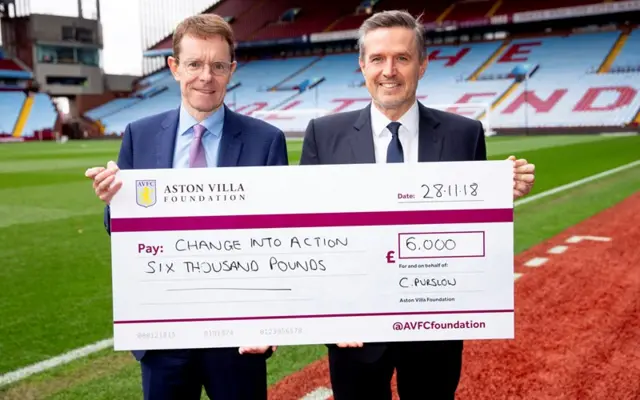 Aston Villa CEO Christian Purslow (right) hands a cheque for £6,000 to Mayor of the West Midlands Andy Street.