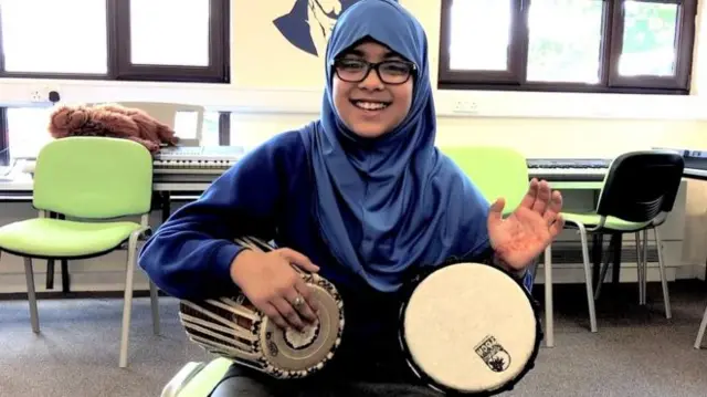 Girl playing the bongos