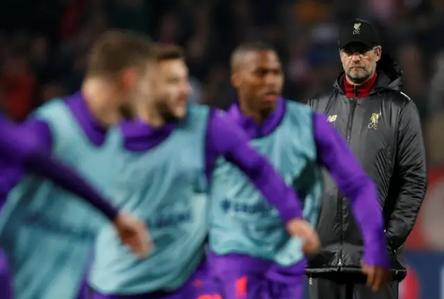 Jurgen Klopp watches his players warm-up