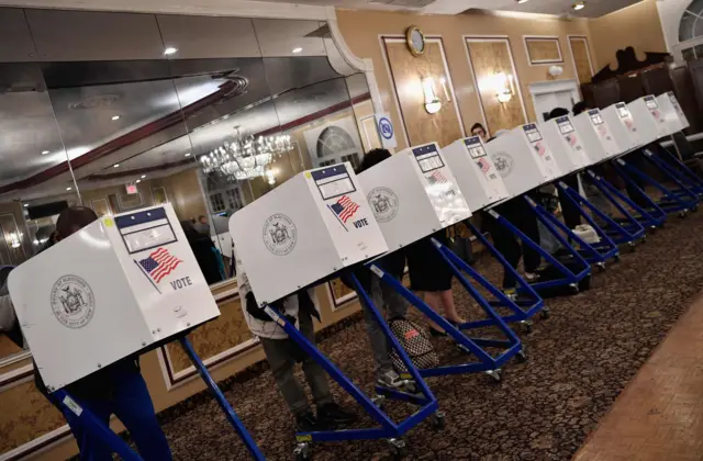 Voters cast their ballot in the midterm election at the East Midwood Jewish Center polling station in the Brooklyn borough of New York City