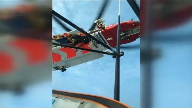 Helicopter flies over boat