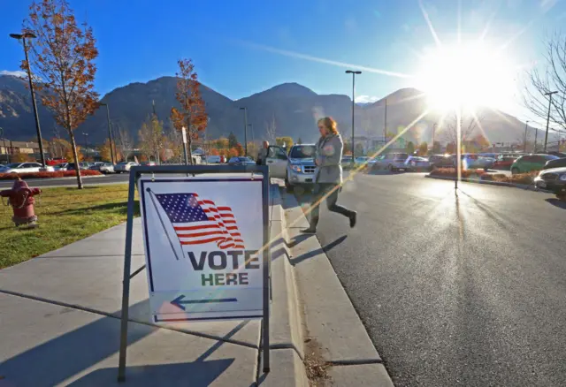 A Utah voter heads to her polling station in the shadow of the Wasatch Mountains