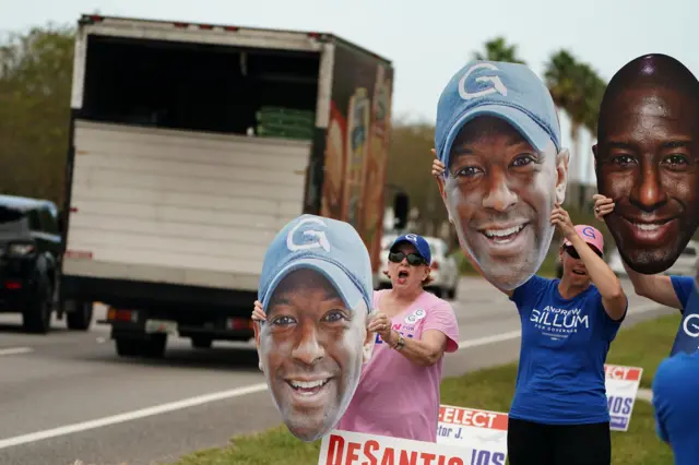 People hold signs supporting Democratic candidate for governor Andrew Gillum at a polling place during the midterm elections in Ponte Vedra Beach, Florida,