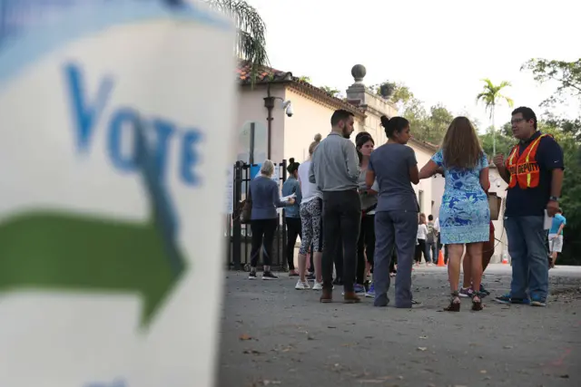 Voters line up to cast their ballot just before the polls open in the mid-terms in Miami, Florida