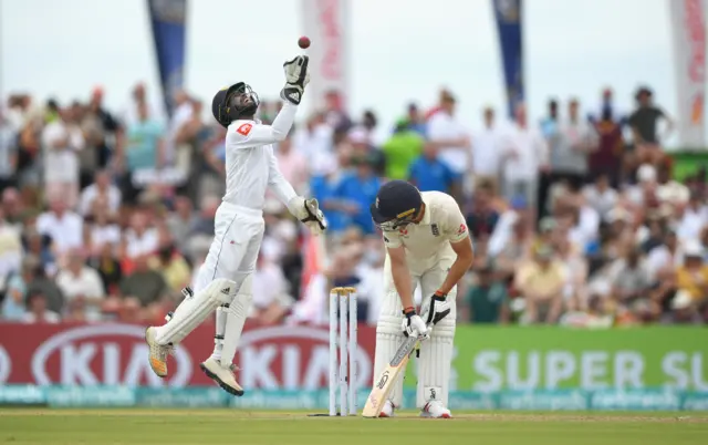 England batsman Jos Buttler reacts as Sri Lanka wicketkeeper Niroshan Dickwella celebrates catching him