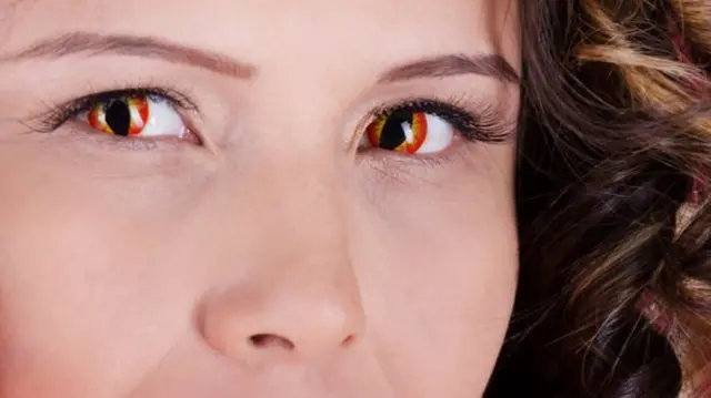 Woman wearing cats eye contact lenses