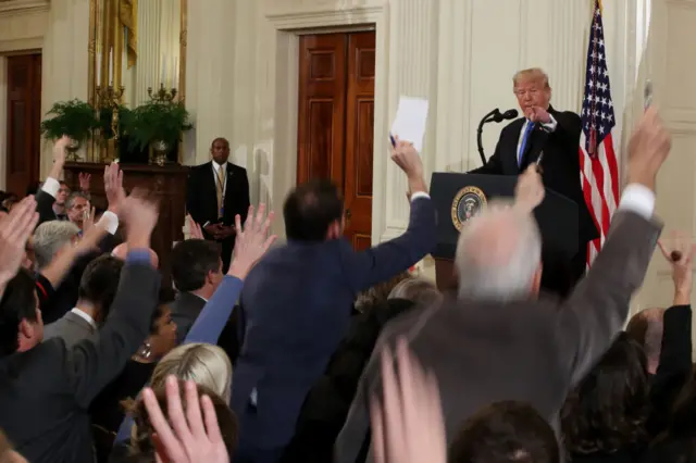 Journalists ask questions at a Trump news conference