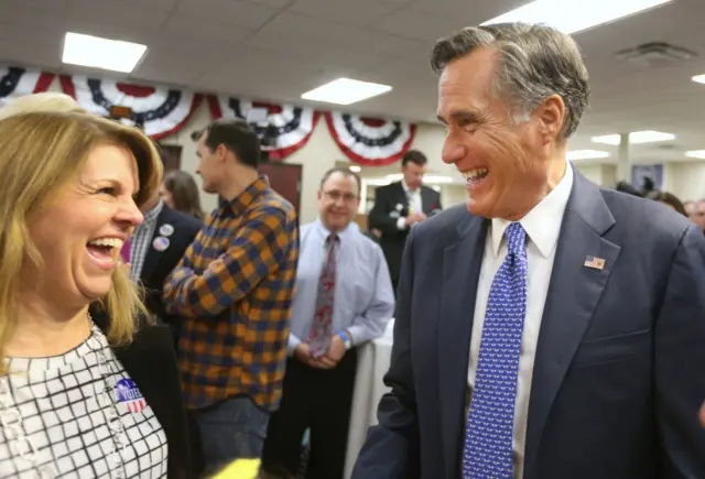 Republican U.S Senate candidate Mitt Romney (L) greets supporters at his headquarters for an election night party