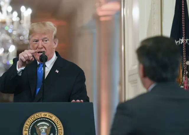 US President Donald Trump points to a journalist during a post-election press conference in the East Room of the White House