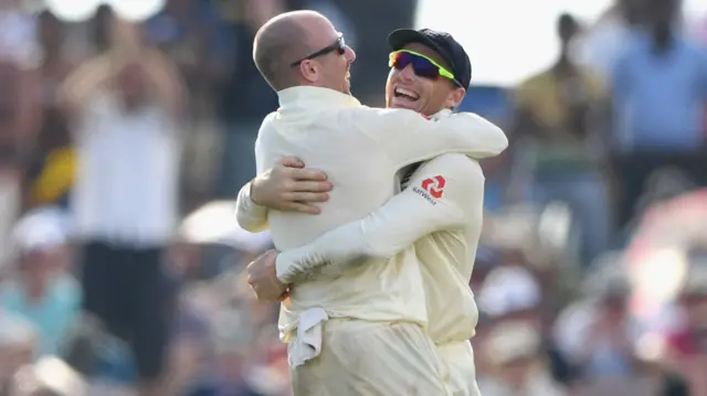 England bowler Jack Leach (l) congratulates Jos Buttler after the pair had combined to dismiss Sri Lanka batsman Perera