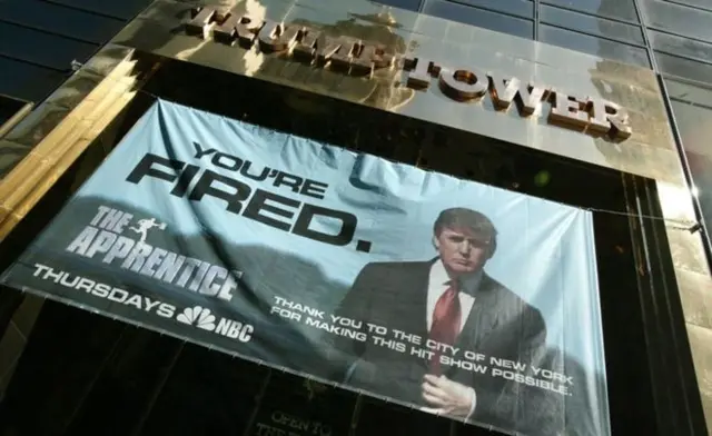 Image of Trump tower with apprentice sign reading YOU'RE FIRED