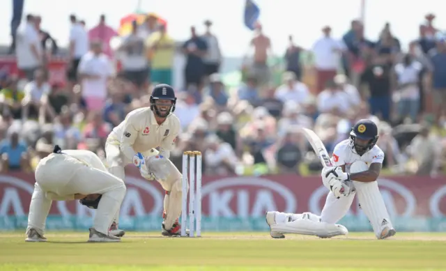 England fielder Rory Burns (l) is hit by a shot from Sri Lanka batsman Niroshan Dickwella