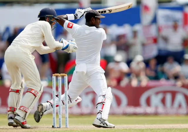 Sri Lanka's Angelo Mathews plays a shot next to England's wicketkeeper Ben Foakes