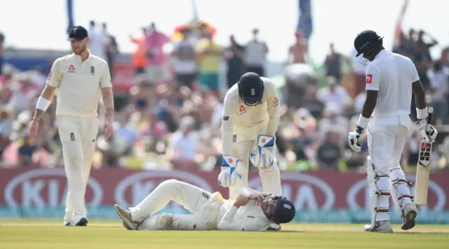 Rory Burns lays flat on the floor after being hit by Dickwella