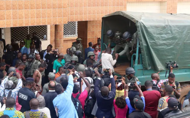 School children are helped to get into a truck by gendarmes in Bamenda, Cameroon