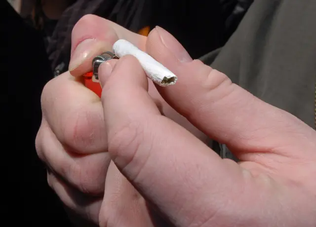 Someone rolls a joint in 2015 file photograph from rally in Michigan