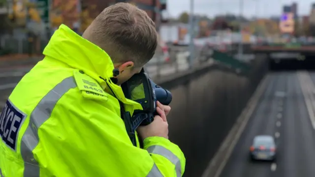 Police officer monitoring drivers