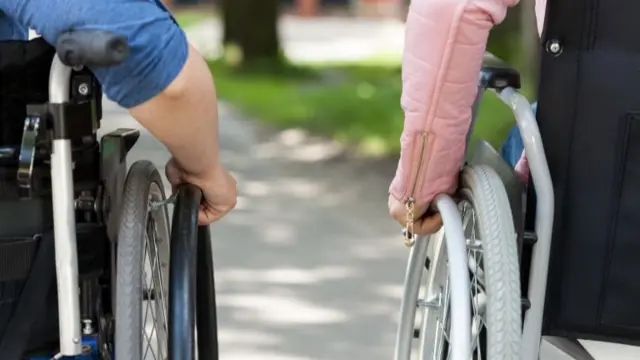 Two people in wheelchairs