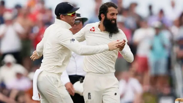 England"s Moeen Ali (R) celebrates with his teammate Jos Buttler after taking the wicket of Sri Lanka"s Dimuth Karunaratne