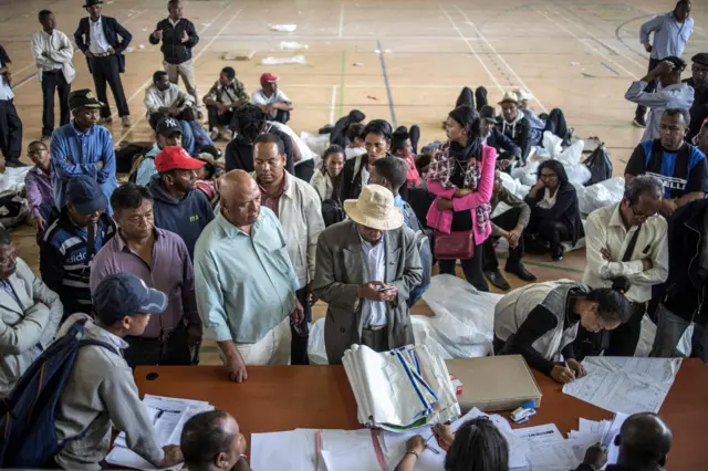 Delegates are seen handing over election reports at the Stade Municipal de Mahamasina Antananarivo, on November 8, 2018 where the national tallying centre has been set up