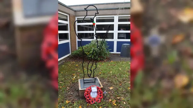 Silhouette of solider above wreath